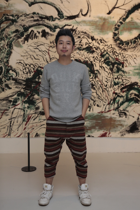 Curator Song Zhenxi stands in front of Sun Xun’s mural, the Chinese contemporary art response to Vivienne Westwood’s exhibition. (Courtesy Photo)