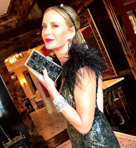 Dee Ocleppo Hilfiger holding Judith Leiber's Paedras in gold and resin bag